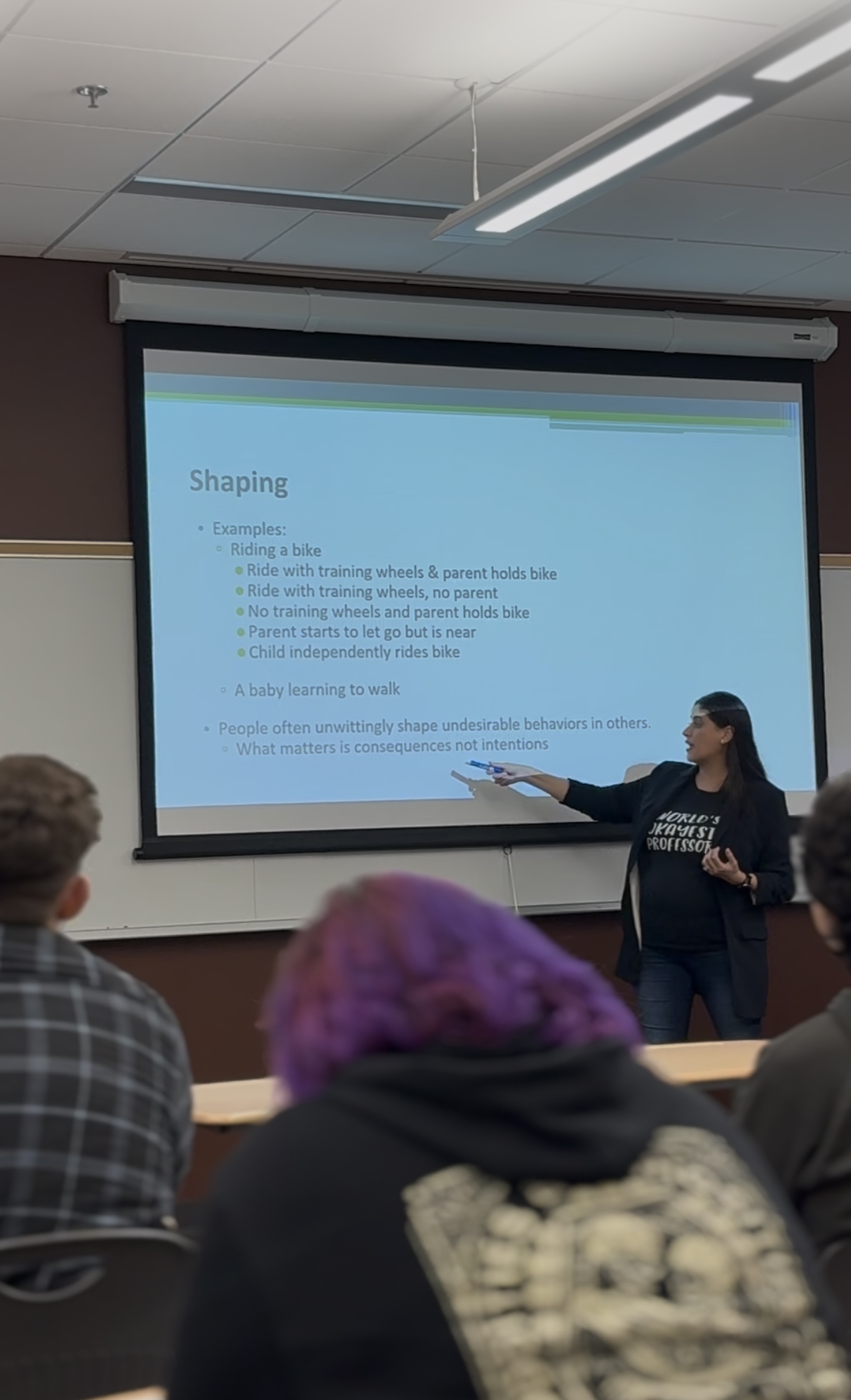 Paola pointing at information on the projector screen